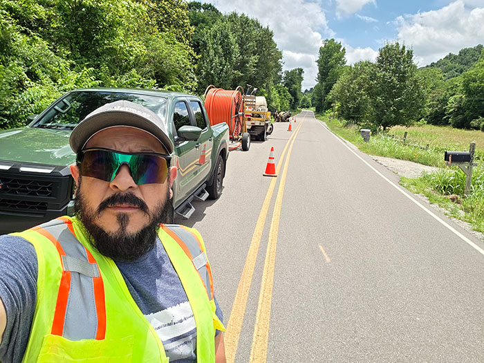 Bonerges Claudino on a roadway performing utility work with his crew and a Vermeer drill