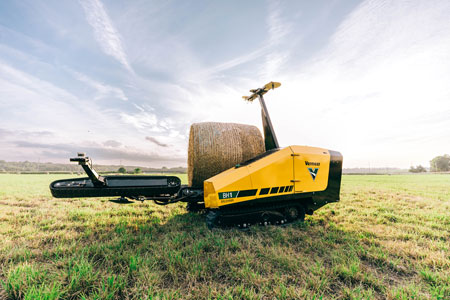 Vermeer bale hawk autonomous bale mover in a field moving a hay bale