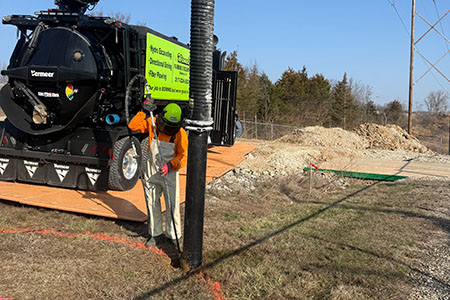 An HDD crew member is using a Vermeer hydrovac