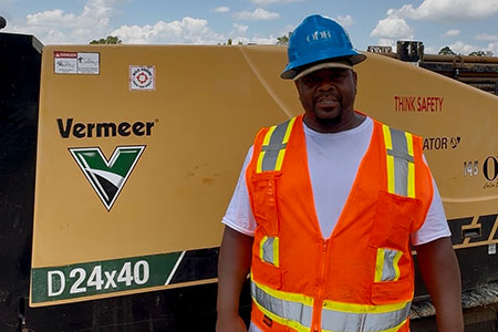 Terrance Johnson wearing PPE standing in front of a Vermeer D24x40 drill