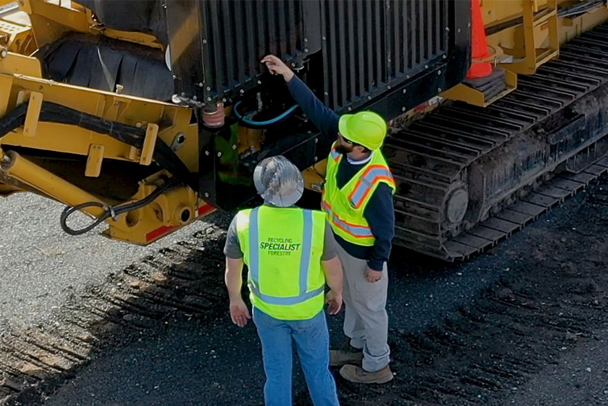 Dealer and customer inspecting a horizontal grinder