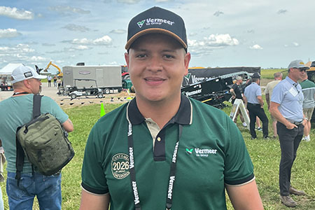 Nayron Rodriguez poses in a field at a Vermeer event in Pella