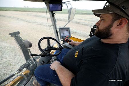 A farmer using Vermeer baling assistance technology in the field