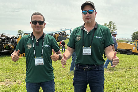 Andres Felipe Guerra Morales and a colleague standing in front of Vermeer directional drills holding up a thumbs up